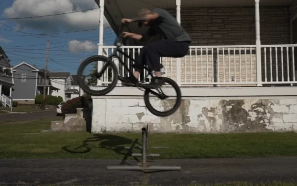 Billy Kennedy tucking a bunnyhop over his rail