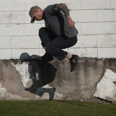 Billy Kennedy doing a split squat jump to show the relationship between riding BMX and the physiology of good body mechanics.