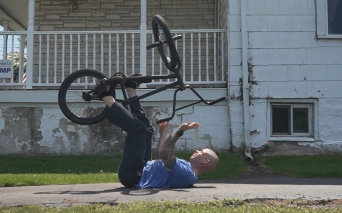 Billy Kennedy Laying on his back to practice barspins