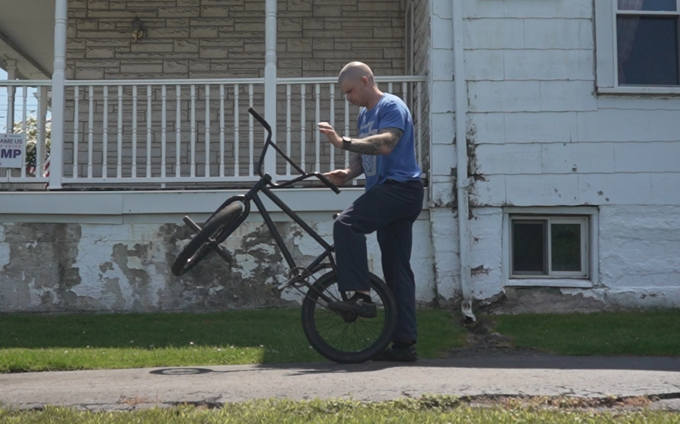 Billy Kennedy performing a peg assisted barspin on a BMX Bike at his home.