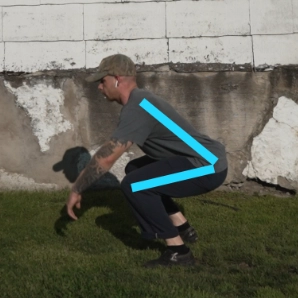 Billy Kennedy doing a squat to show hinging at the hips with colored bars to represent the angle of the hip hinge.